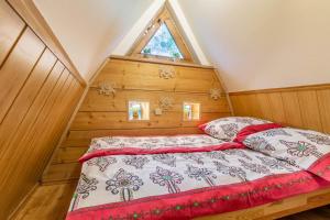 a bedroom with a bed in a room with a window at Stara Chata in Zakopane