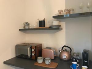 a kitchen counter with a microwave and a toaster at The TollHouse in Stirling