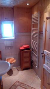 a bathroom with a sink and a toilet and a window at Halmis FeWo in Derenburg