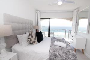 a bedroom with a bed with a view of the ocean at 1002 Bermudas - by Stay in Umhlanga in Durban