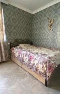 a bedroom with a bed with flowers on it at Home in batumi in Batumi