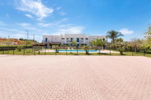 a brick parking lot in front of a building at Appartamento Cristallo by BarbarHouse in Torre Lapillo +18 photos