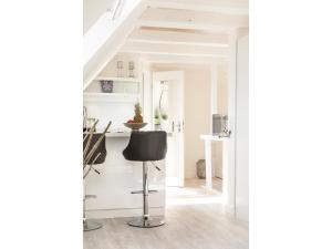 a white room with a black chair in it at Ferienwohnung - Tessa in Tinnum