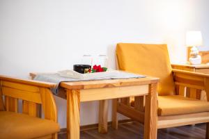 a table with a plate of food and two chairs at Penzión PALATÍN in Rajecké Teplice