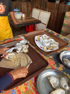 a table with two trays of oysters on it at CabinStay Cikgu Sungai Batu Besi in Sungai Petani