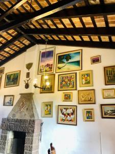 a wall with a bunch of pictures on it at Hosteria Fortin de San Miguel in Chuy