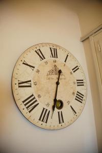 a clock on a wall with roman numerals on it at Laincel - Clim - Balcon in Arles