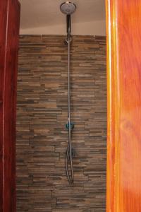 a shower in a room with a brick wall at Villa Rosanna in Sciacca