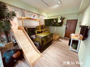 a kids room with a toy truck and a slide at Yo Trip in Tainan
