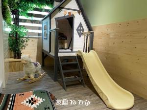 a small play area with a doll house and a slide at Yo Trip in Tainan +28 photos