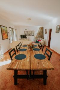 a wooden table and chairs in a living room at Casa Joaquina in Carvoeiro