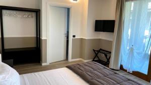 a bedroom with a bed and a sliding glass door at Foresteria Green House in Seriate