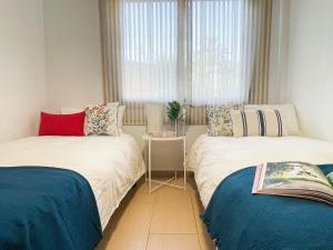 Llit o llits en una habitació de Apartamento con gran patio a 1 min de la playa