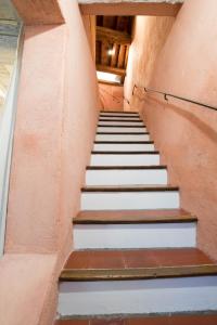un escalier dans un bâtiment blanc et marron dans l'établissement Perchoir - Terrasse, à Arles 18 autres photos