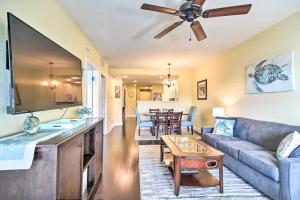a living room with a couch and a table at Waterfront Condo with Water Park, Walk to the Beach! in Clearwater Beach
