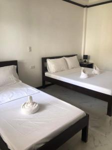 Кровать или кровати в номере Hotel Oasis Port Barton