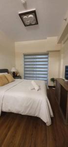 Ένα ή περισσότερα κρεβάτια σε δωμάτιο στο JCGA Apartments at Bristle Ridge Condominium Near Botanical Garden and The Mansion