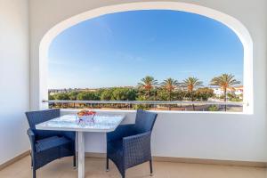 a dining room with a table and chairs and a large window at Hotel Maritur - Adults Only in Albufeira