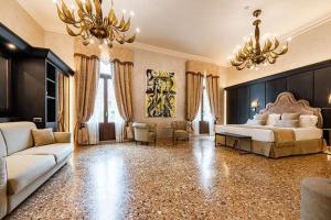 a large bedroom with a bed and a chandelier at Hotel Aquarius Venice - Ascend Collection in Venice