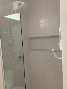 a bathroom with a shower with a glass door at Almas Gêmeas suíte in Angra dos Reis +25 photos