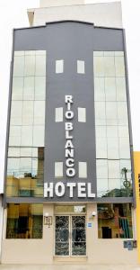 a hotel sign on the side of a building at Hotel Rio Blanco in Piura