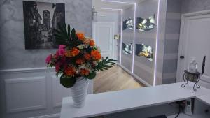 a vase filled with flowers on a table in a room at B&B MaisonAlysie in Foggia