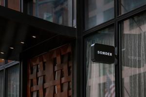 a sign on the door of a store at Sonder Chambers in New York