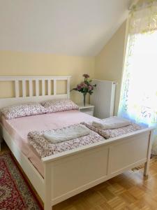 a bedroom with a white bedspread and white pillows at Apartments Maria in Ljubljana