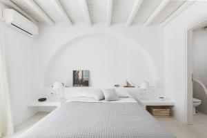 a white bedroom with a bed and white walls at Mesmerizing 5bed Villa with Pool in Kanalia in Agios Ioannis Mykonos +34 photos