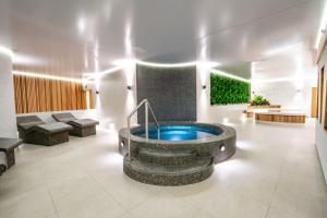 a lobby with a hot tub in the middle of a room at TLH Victoria Hotel - TLH Leisure, Entertainment and Spa Resort in Torquay