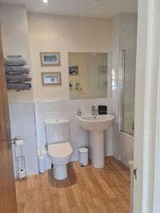 a bathroom with a toilet and a sink at Southcourt in Worthing