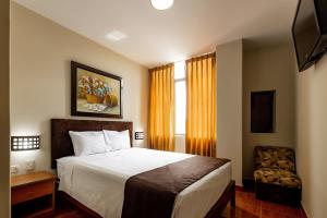En eller flere senger på et rom på Hotel Rio Blanco