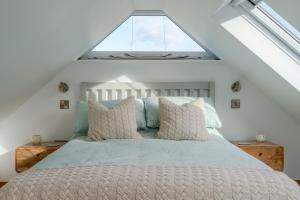 1 dormitorio con 1 cama y ventana grande en Hillview Hideaway with Hot Tub en Cheltenham
