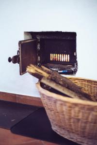a wicker basket with a heater on top of a counter at Das Detox Almhaus in Pusterwald