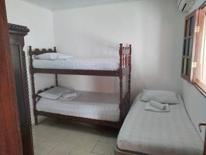 a couple of bunk beds in a room at Casa Milagres in São Miguel dos Milagres