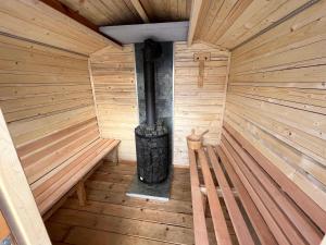 an inside of a wooden sauna with a stove at Domek w Chmurach in Kicznia