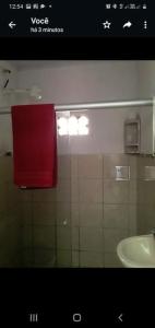 a bathroom with a red towel and a sink at Casa Milagres in São Miguel dos Milagres