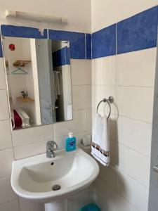 a bathroom with a sink and a mirror at Lyshima’s Cozy Studio in Nairobi