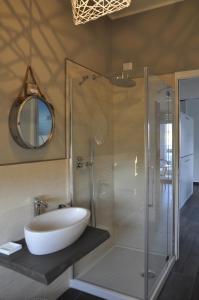 a bathroom with a sink and a glass shower at Casa Marzi in Pesaro +14 photos