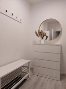 a dressing room with a mirror and a dresser at Berg-Blick-Fewo in Bad Harzburg