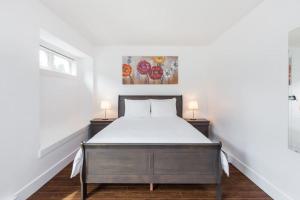 a bedroom with a bed and two night stands at West Coast Luxury Living in Vancouver