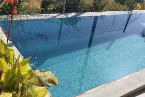 a fence around a swimming pool with a net at Canto da Manu Panoramic in Calheta