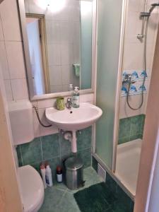 a bathroom with a sink and a shower at Apartment Surya in Rogoznica +28 photos