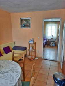 a bedroom with a bed and a living room at Apartment Surya in Rogoznica