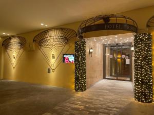 a hotel lobby with a hotel sign on the wall at Hotel Roma in Bologna