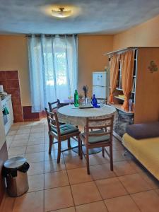 a living room with a table and chairs and a couch at Apartment Surya in Rogoznica