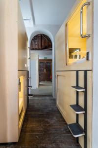 a kitchen with wooden cabinets and a hallway at HosteLit, Capsule Hostel in Santa Cruz de la Palma