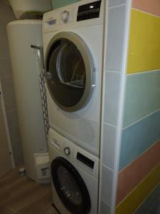 a washer and dryer in a corner of a room at LES GITES D'AULT. Meublé Le Hâble d'Ault. in Ault