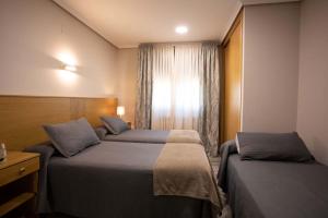 Postel nebo postele na pokoji v ubytování PENSIÓN CASA ANTONIO
