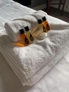 three bottles of soap sitting on a towel on a bed at The Lambton Arms in Durham
